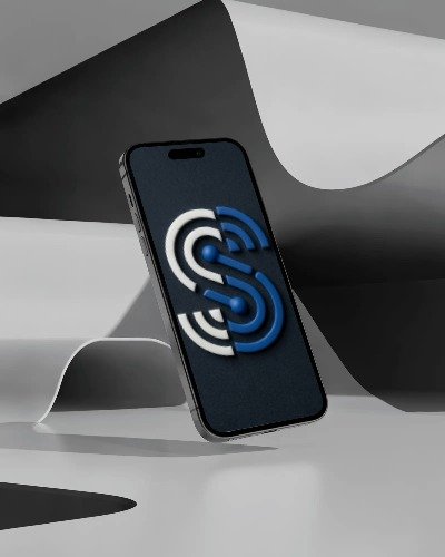 A phone floating above folded paper, its screen showing the Sydrek signal mark